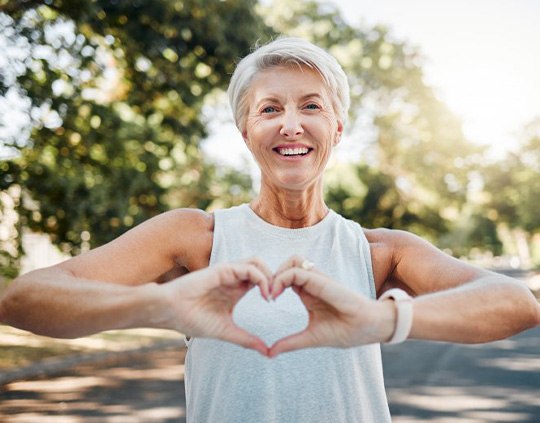 Lady makes shape of heart with her hands