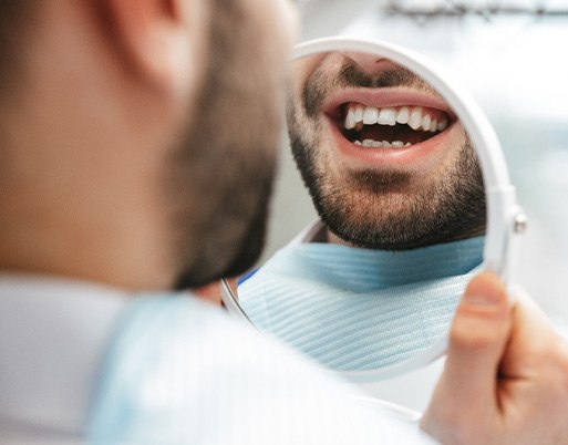 Patient looking at smile in reflection