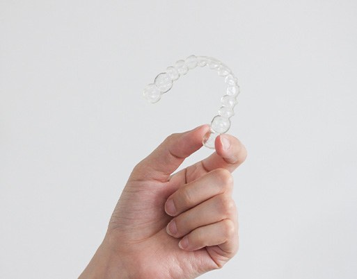 Closeup of patient holding clear aligner