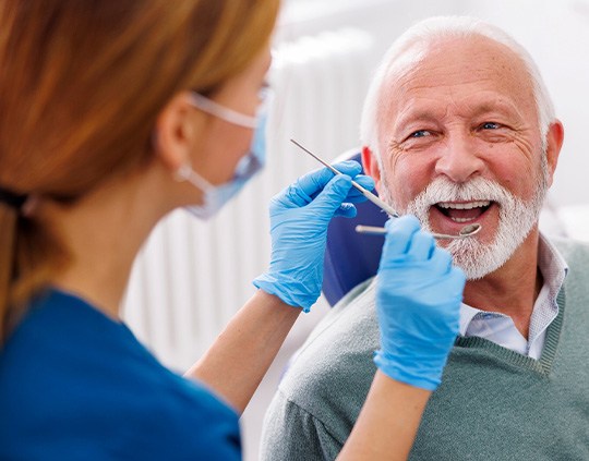 Man smiles at dental hygienist