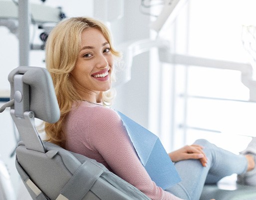 Woman smiling while sitting in treatment chair