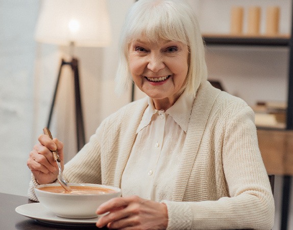 A woman eating soup