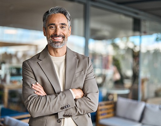 Man smiling with his new dental implants
