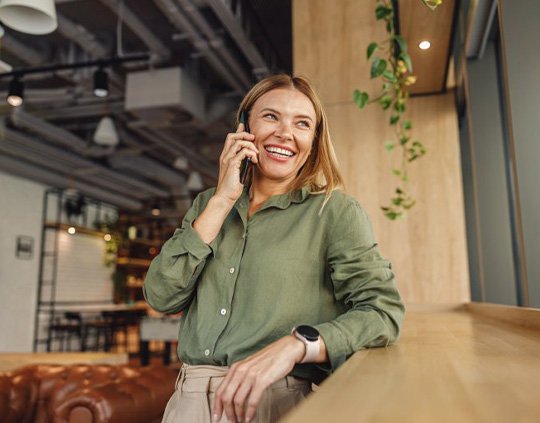 Lady smiles while making important phone call