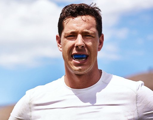 Man wears athletic mouthguard