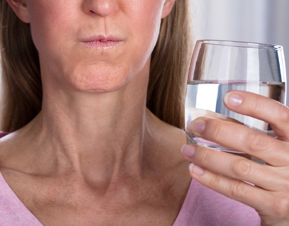 A woman rinsing her mouth with mouthwash