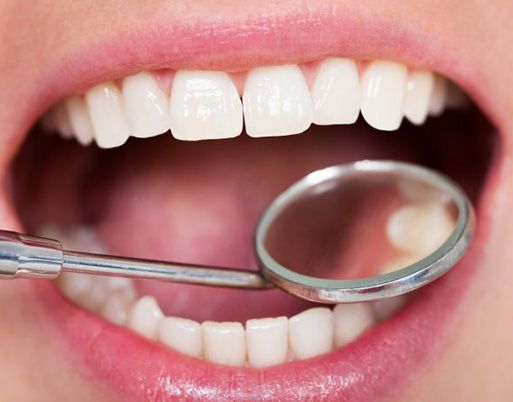 Teeth examined with dental mirror