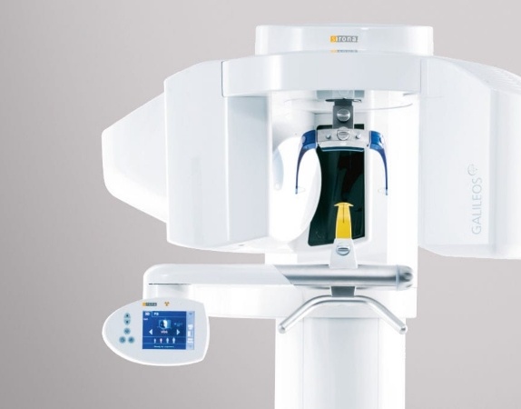 C T cone beam dental scanner against white wall