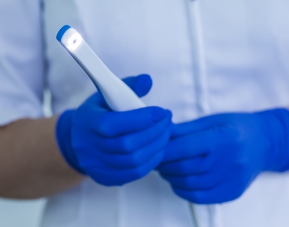 Dental professional holding an intraoral camera