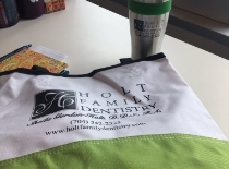 Holt Family Dentistry logo and contact information on cloth