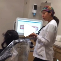 Doctor Gordon Holt talking to a patient in the dental chair