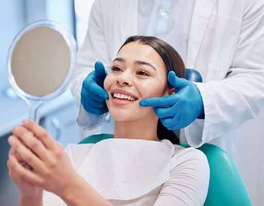 Woman smiling at reflection in mirror