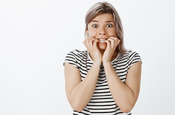 Woman biting her nails nervously