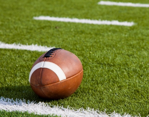 Football resting on football field