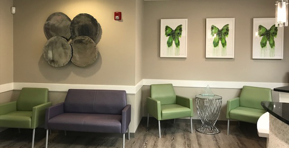 Artwork of green butterflies on wall of reception area