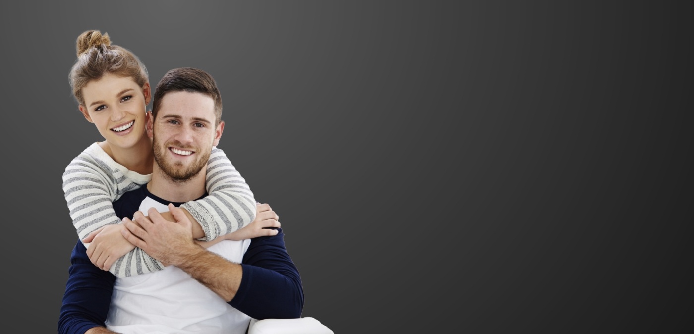 Smiling man and woman embracing after preventive dentistry in Charlotte