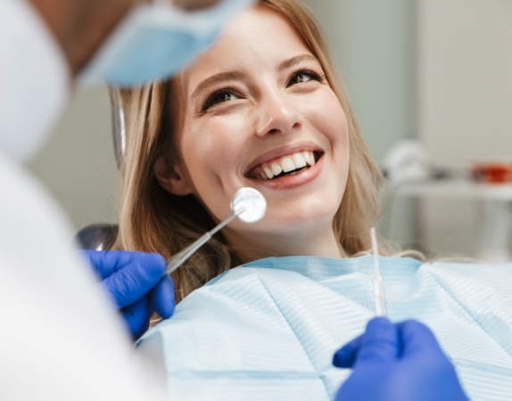 Woman smiling at her dentist during dental checkup