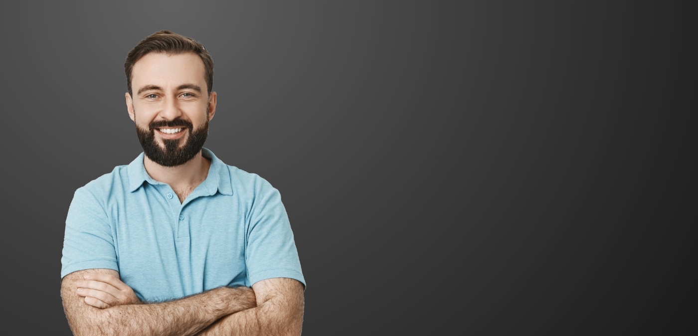 Smiling man in blue polo shirt