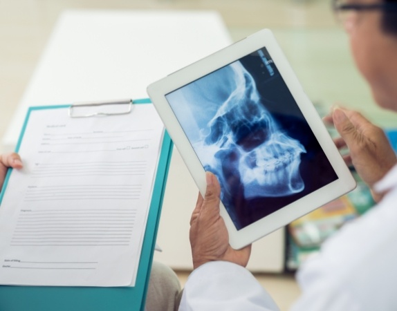 Dentist looking at X rays of the jaw