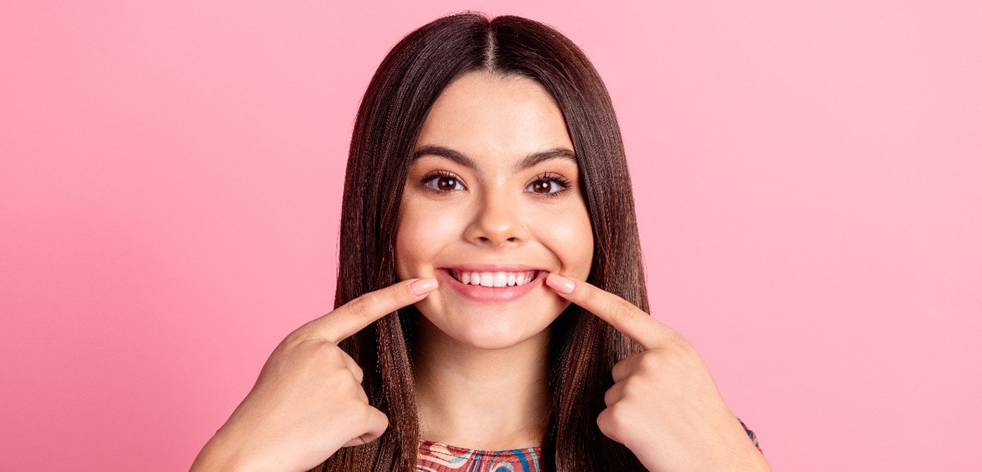 Woman pointing to her teeth