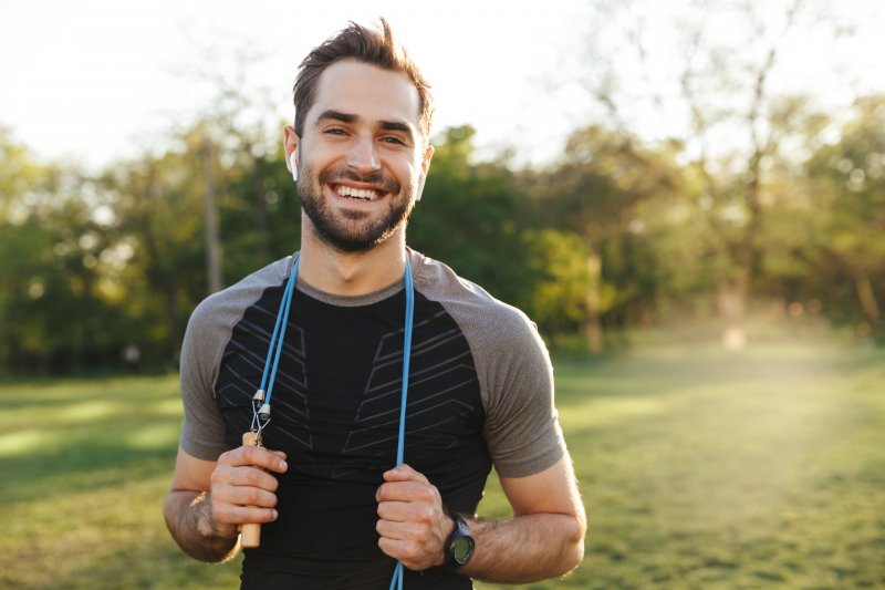 dental implants patient smiling after jump-roping.